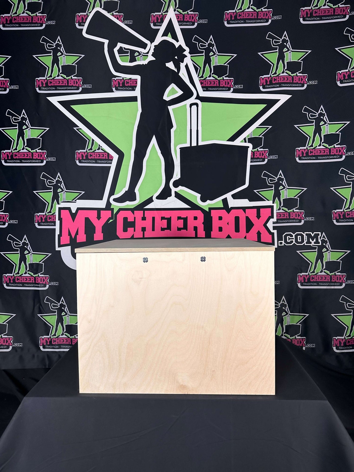 15" collapsible bare bones cheer box with no exterior design, featuring nylon carry handles and lid hooks, displayed on a branded backdrop.